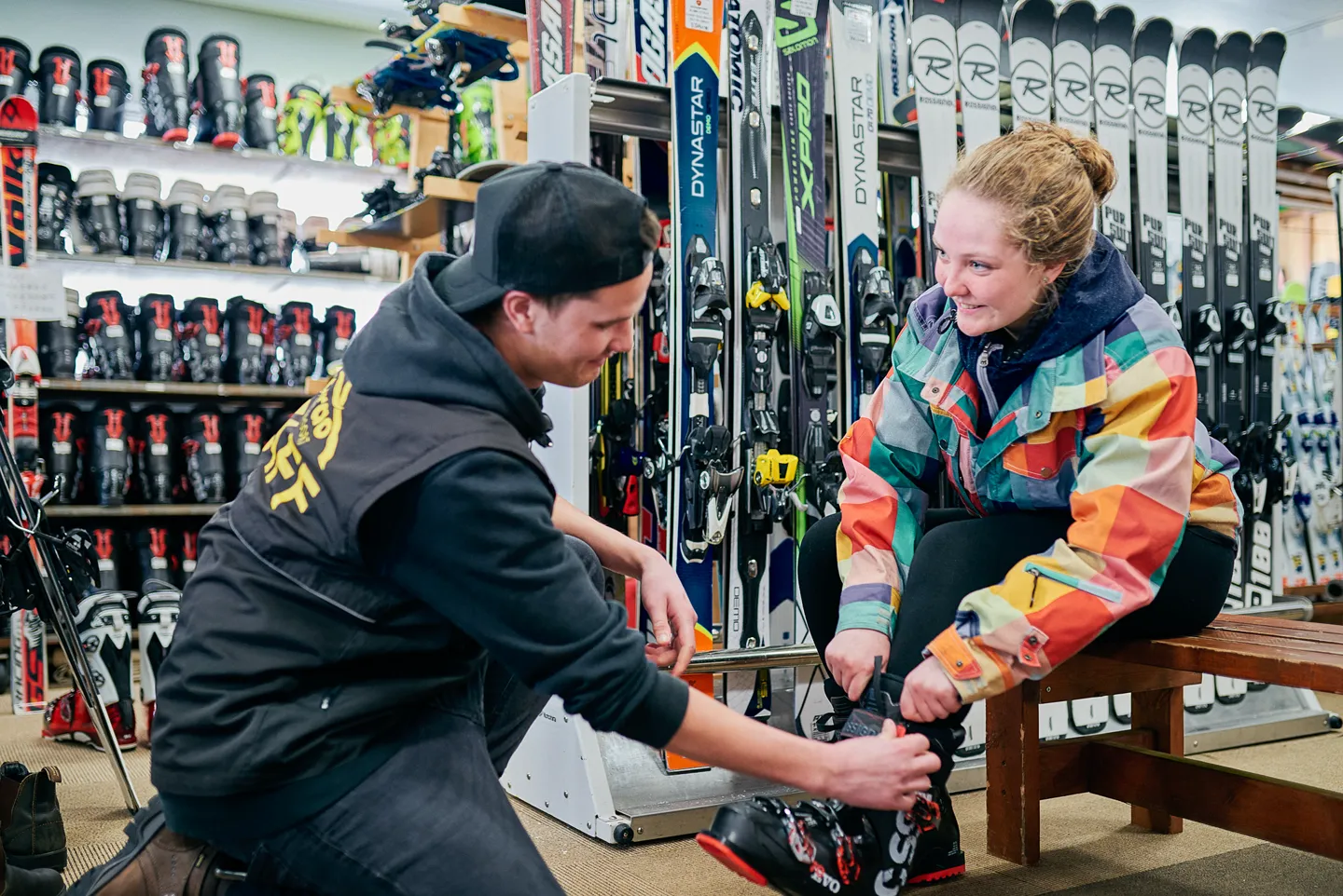 Staff fitting rental boots at Shirakaba Rental, Madarao Kogen Hotel